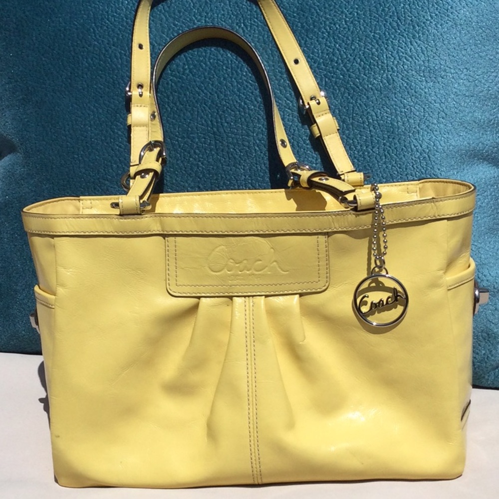 Coach yellow zipper top closure hand bag.